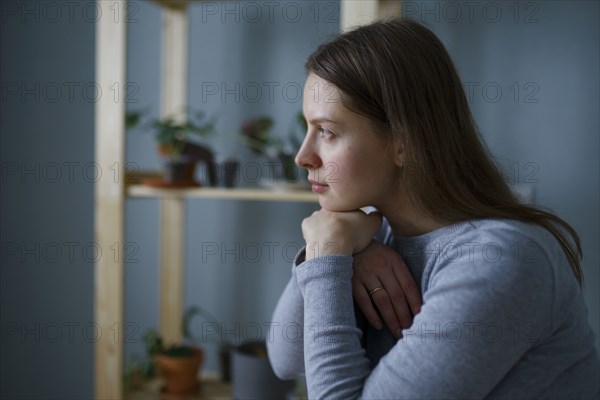 Portrait of thoughtful woman with hands on chin