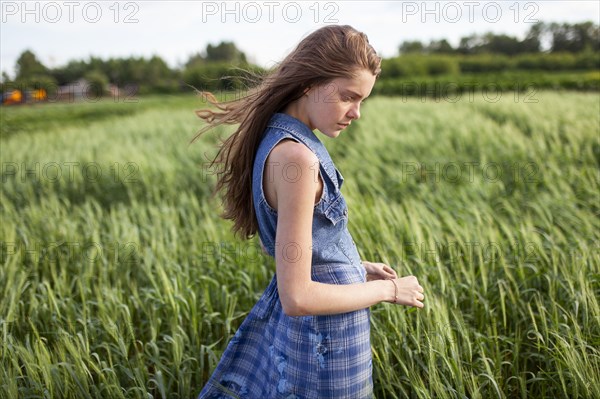 Portrait of woman standing in field