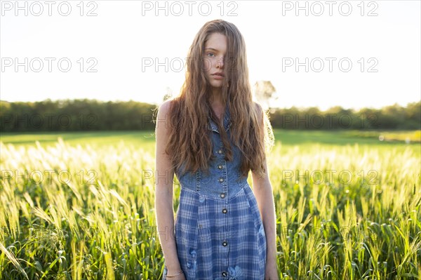 Portrait of woman standing in field
