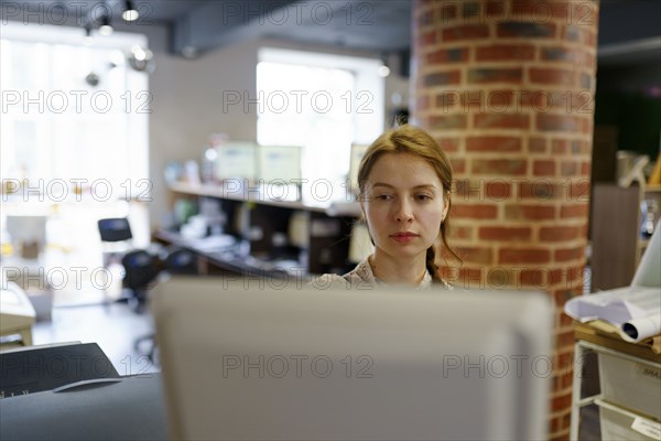 Focused woman working in printing plant