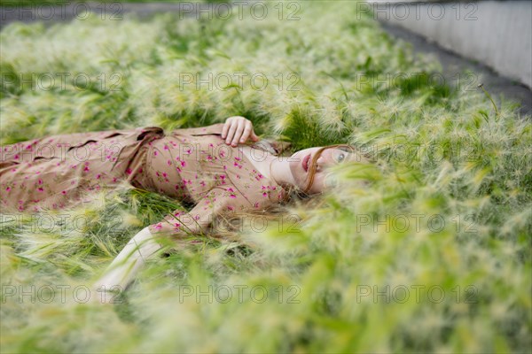 Portrait of woman lying on grass