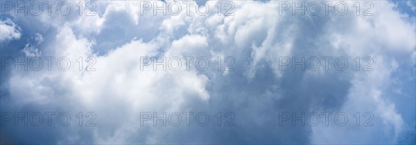 Puffy white and blue clouds on sky