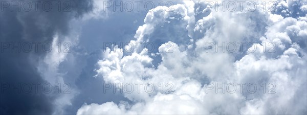 Puffy white and blue clouds on sky