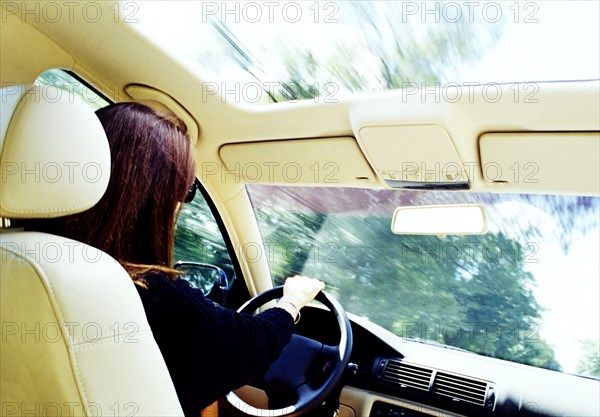 Rear view of woman driving car