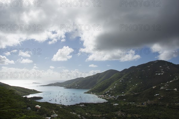 Thick clouds over Coral Bay with sailboats