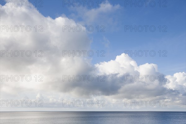 White puffy clouds over sea