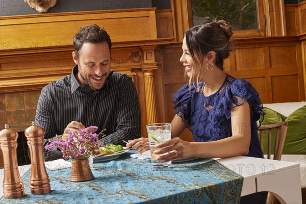 Smiling couple enjoying dinner at home