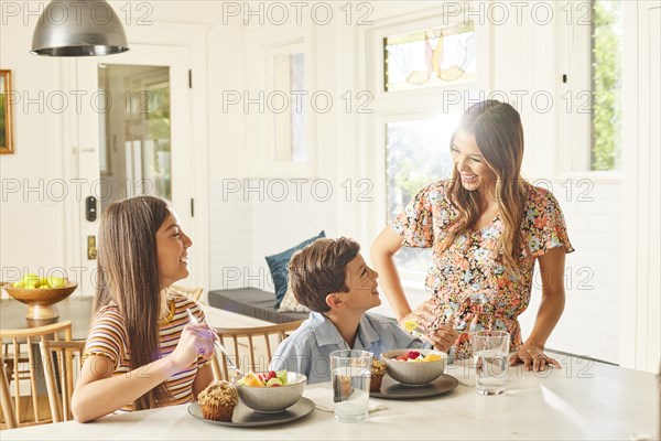 Smiling mother with son and daughter