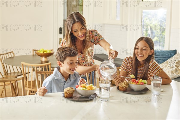Smiling mother with son and daughter