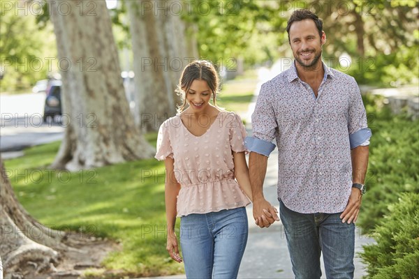 Smiling couple holding hands