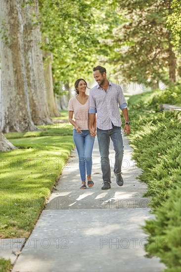 Smiling couple holding hands