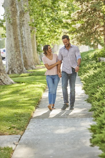 Smiling couple holding hands