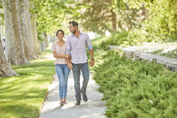 Smiling couple holding hands