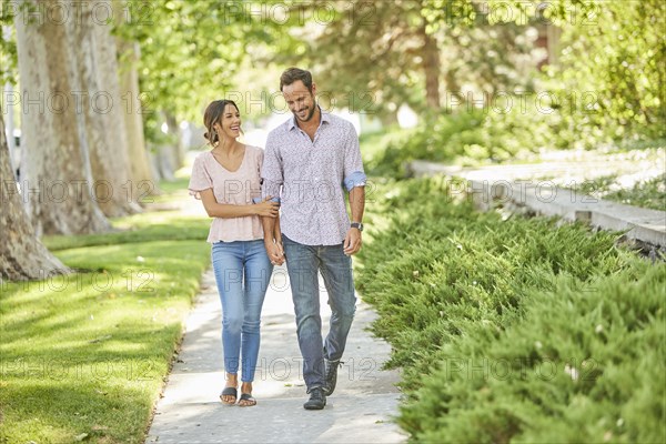 Smiling couple holding hands