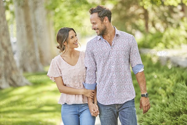 Smiling couple holding hands