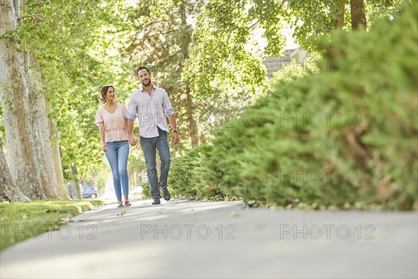 Smiling couple holding hands