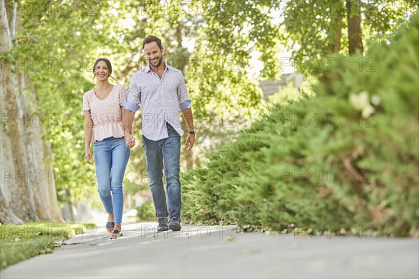 Smiling couple holding hands