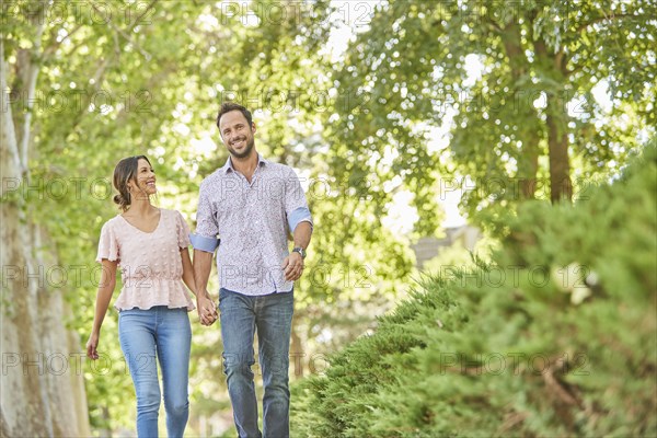 Smiling couple holding hands