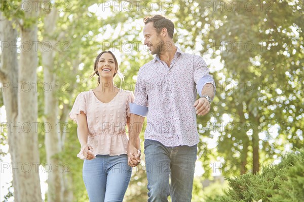 Smiling couple holding hands