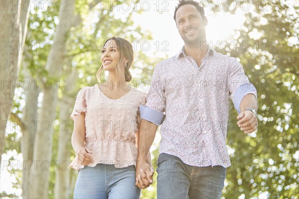 Smiling couple holding hands