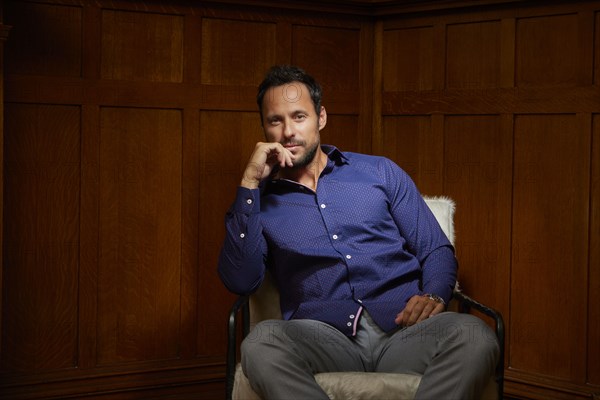 Portrait of mid adult man sitting on chair