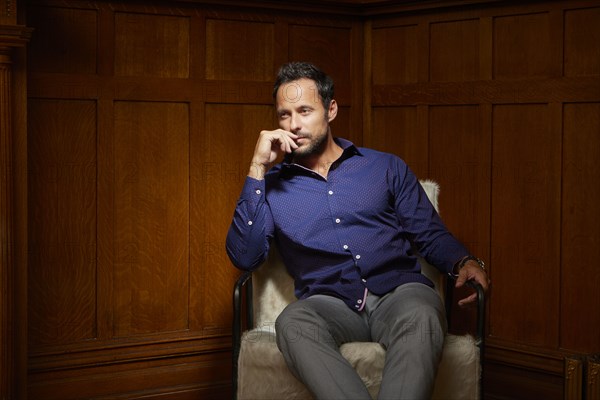 Mid adult man sitting on chair