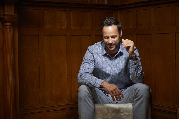 Smiling mid adult man sitting on chair