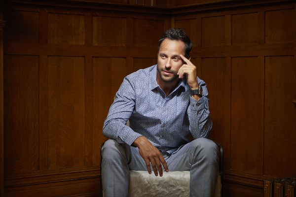 Mid adult man sitting on chair