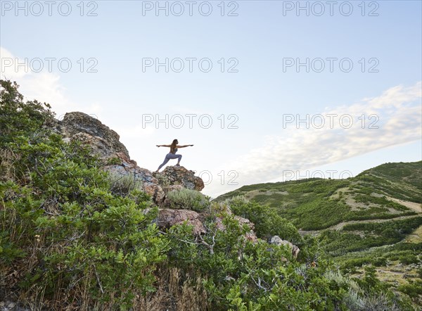 Mid adult woman doing yoga in mountains