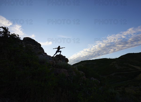 Mid adult woman doing yoga in mountains