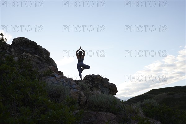 Mid adult woman doing yoga in mountains