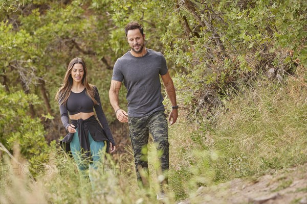 Mid adult couple hiking in forest