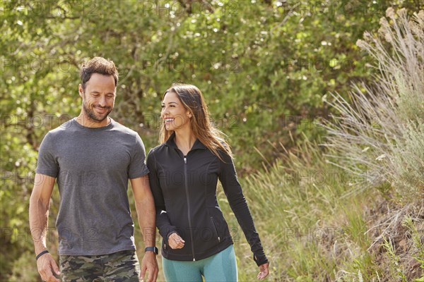 Mid adult couple hiking in forest