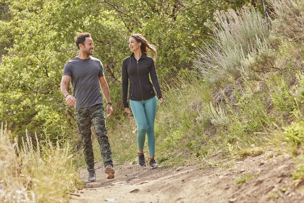 Mid adult couple hiking in forest