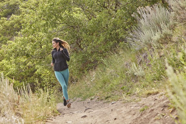 Mid adult woman jogging outdoors