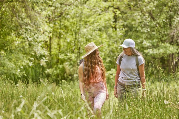 Mother and adult daughter hiking in forest