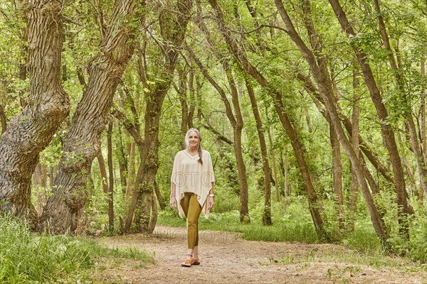 Smiling mature woman walking in park