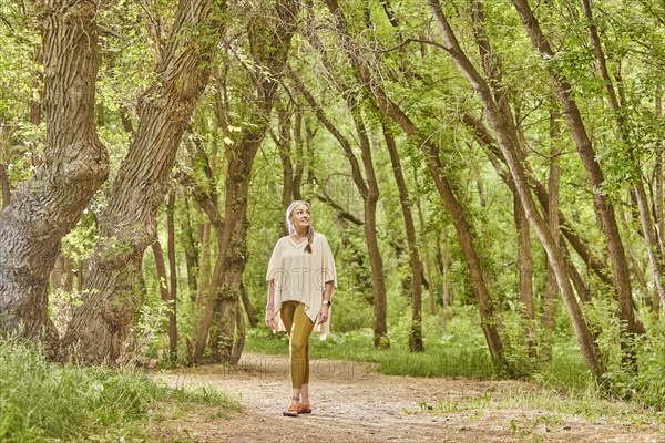 Smiling mature woman walking in park