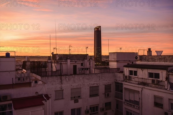 Modern skyscraper and old town architecture at sunset