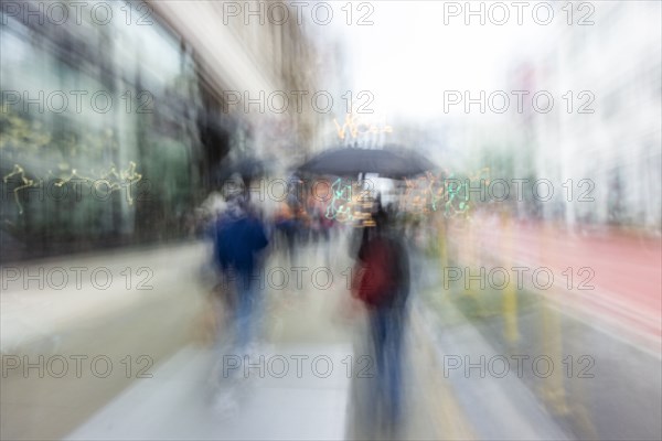 Blurred image of people walking on city street