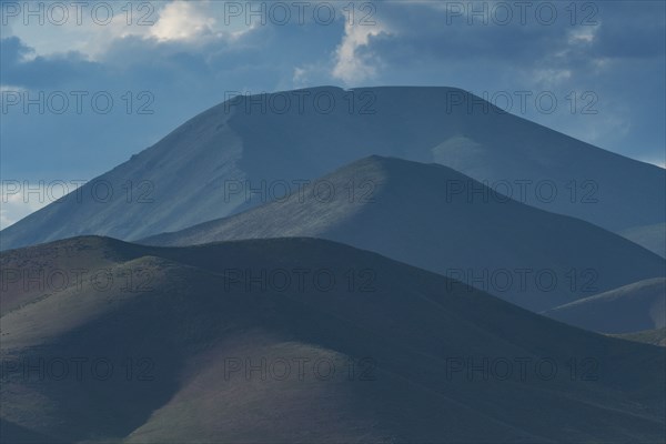 Clouds above mountains at sunset