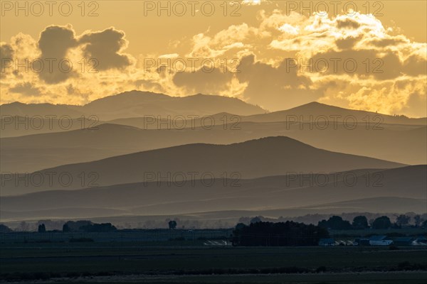 Clouds above mountains at sunset