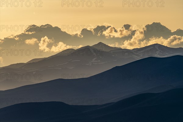 Clouds above mountains at sunset