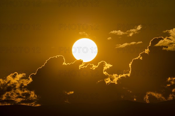 Sky with clouds and setting sun