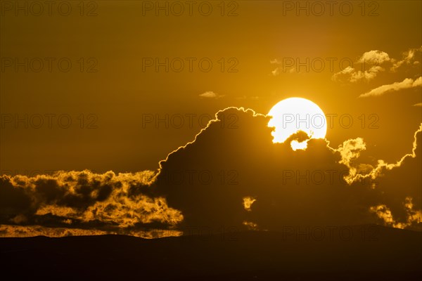 Sky with clouds and setting sun