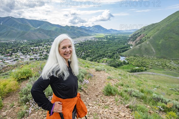 Senior blonde woman hiking on Carbonate Mountain trail