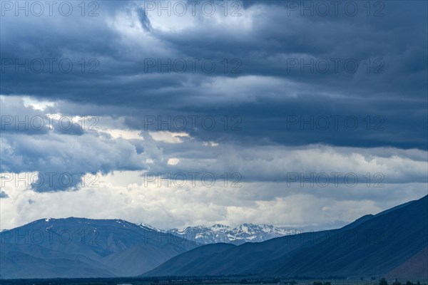Dramatic view of storm clouds over mountains