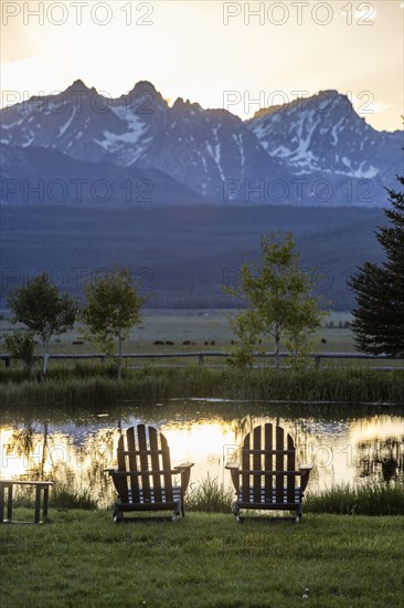Scenic view of Sawtooth Mountains with pond at sunset