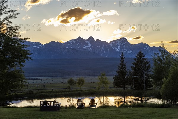 Scenic view of Sawtooth Mountains with pond at sunset