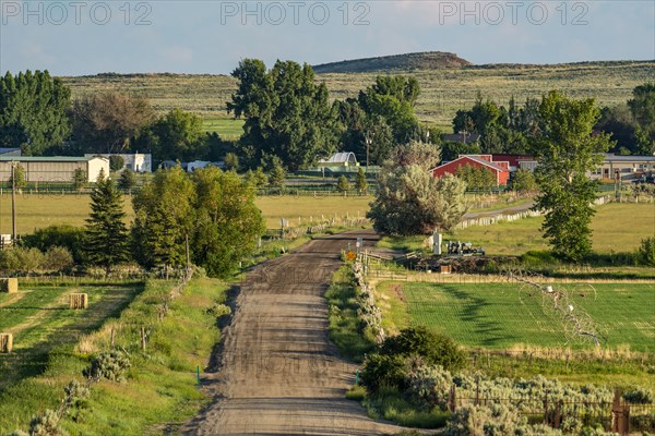 Rural landscape with dirt road leading to village